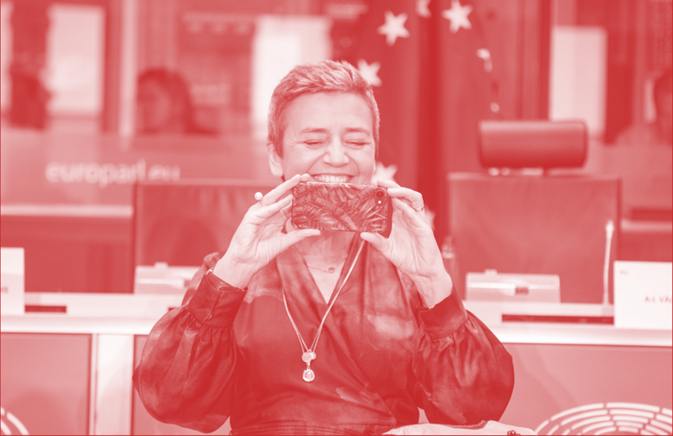 Margrethe Vestager holding a phone and smiling ahead of European Parliament hearings in 2019 