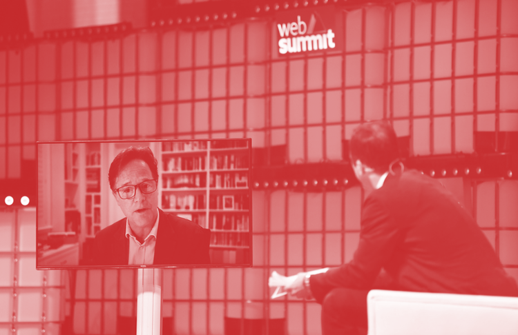 Nick Clegg, VP of Global Affairs & Communications, talking on screen, left, to a man on stage at Web Summit 2021 