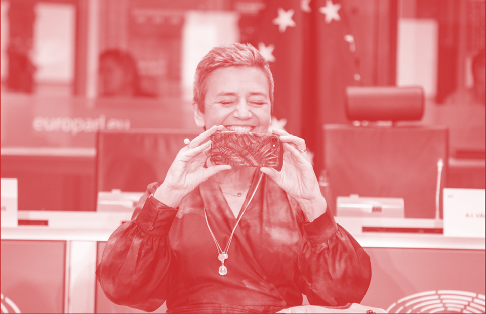 Margrethe Vestager holding a phone and smiling ahead of European Parliament hearings in 2019