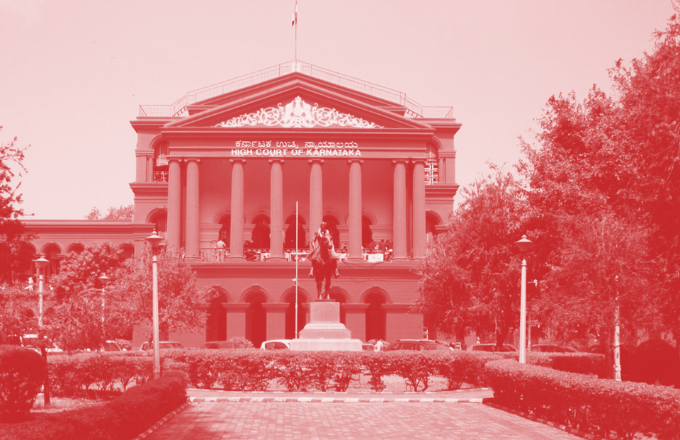 The Karnataka High Court with box hedges leading up to a statue in front of a large building